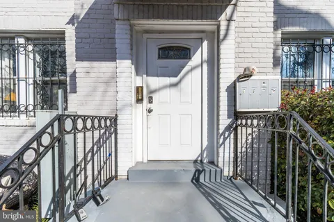 a view of a balcony with wooden floor and fence