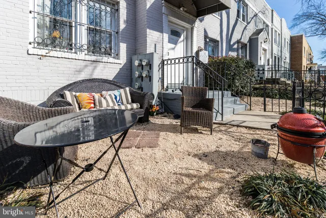 a view of a balcony with table and chairs