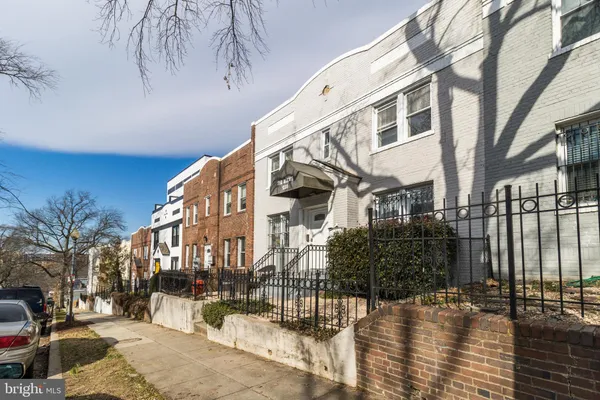a view of a building with a snow on the road