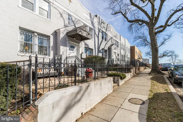 a view of tall buildings with the trees