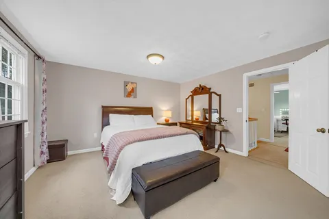 a bed room with a bed and a chair