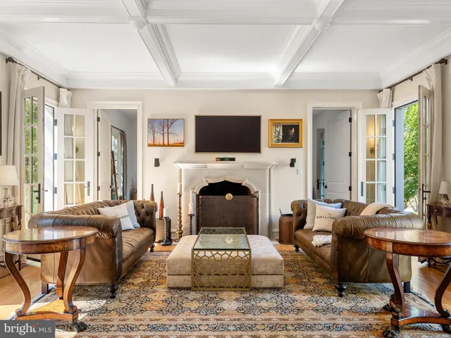 a living room with furniture a fireplace and a table