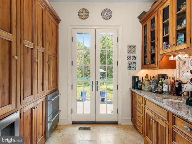 a view of staircase with lots of frames on wall and a window