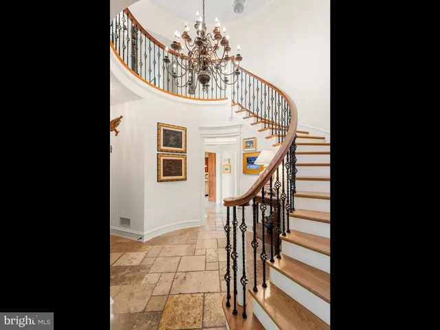 a view of a swimming pool with lawn chairs under an umbrella