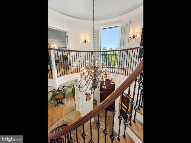 a view of a house with a big yard and large trees