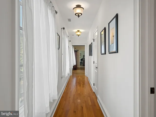 an aerial view of a house with swimming pool and mountains