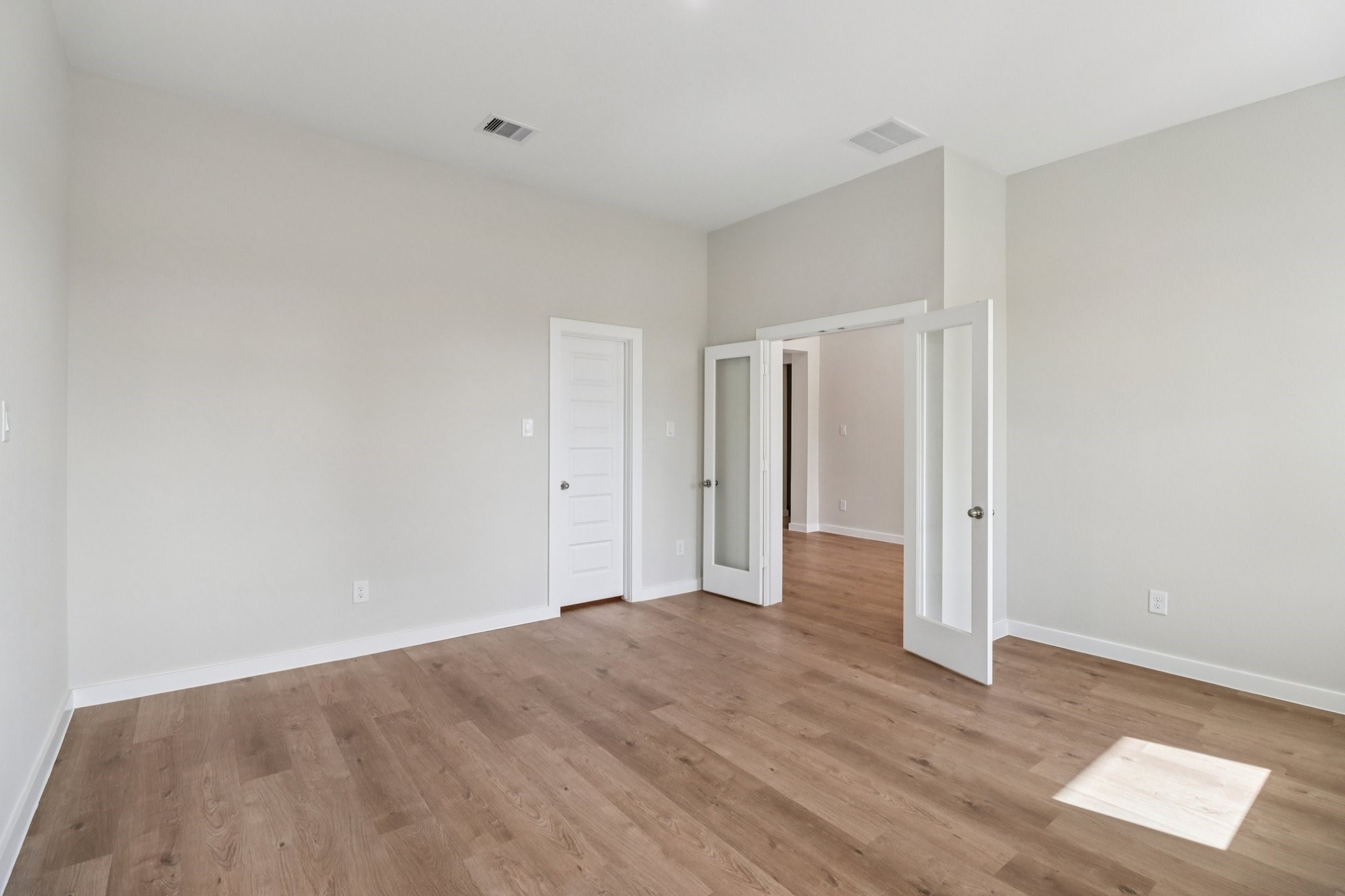 13424 Maverick Trail Road Conroe, TX 77303 - Photo 14 of 35 a view of an empty room with wooden floor and a window