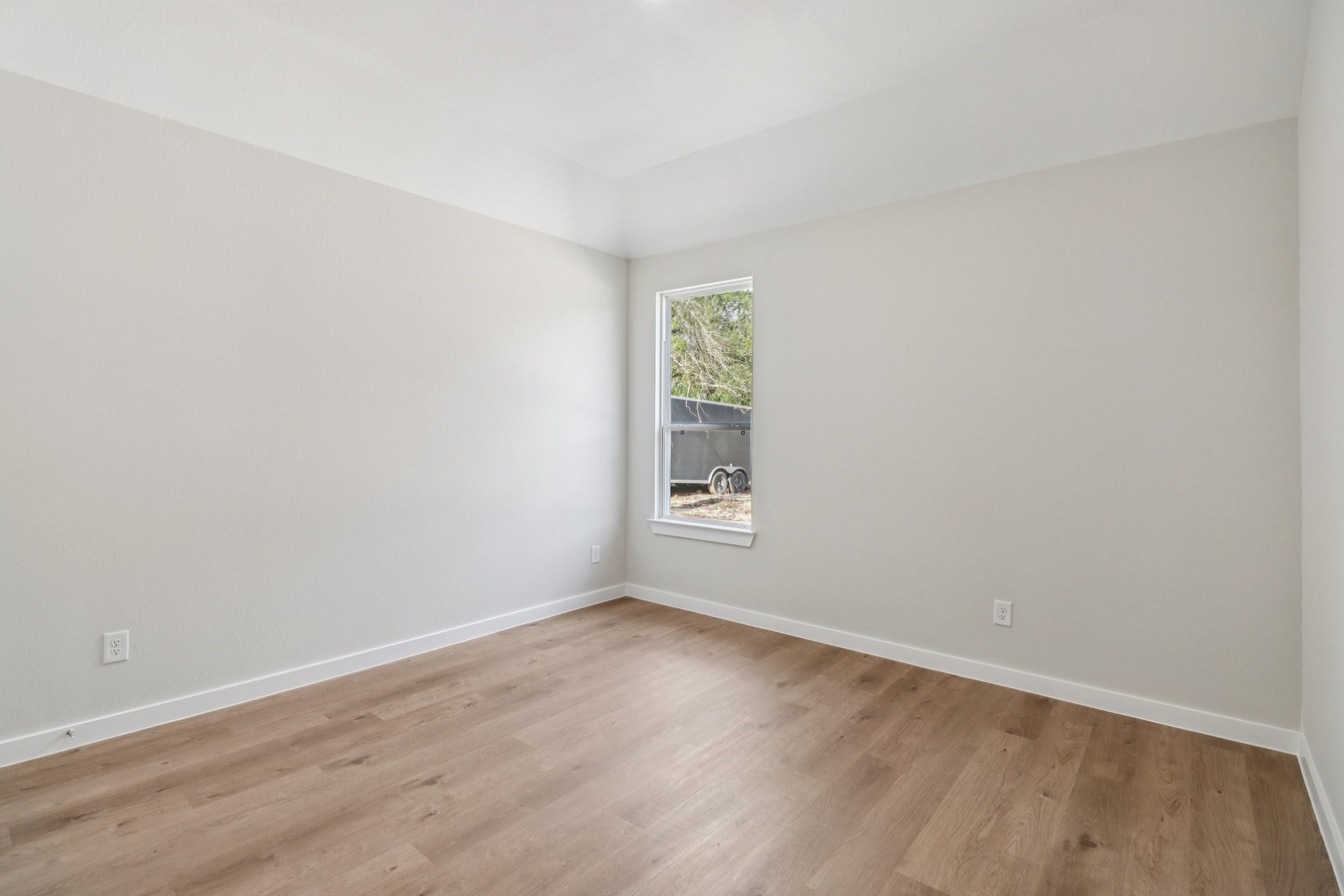 13424 Maverick Trail Road Conroe, TX 77303 - Photo 17 of 35 a view of an empty room with wooden floor and a window