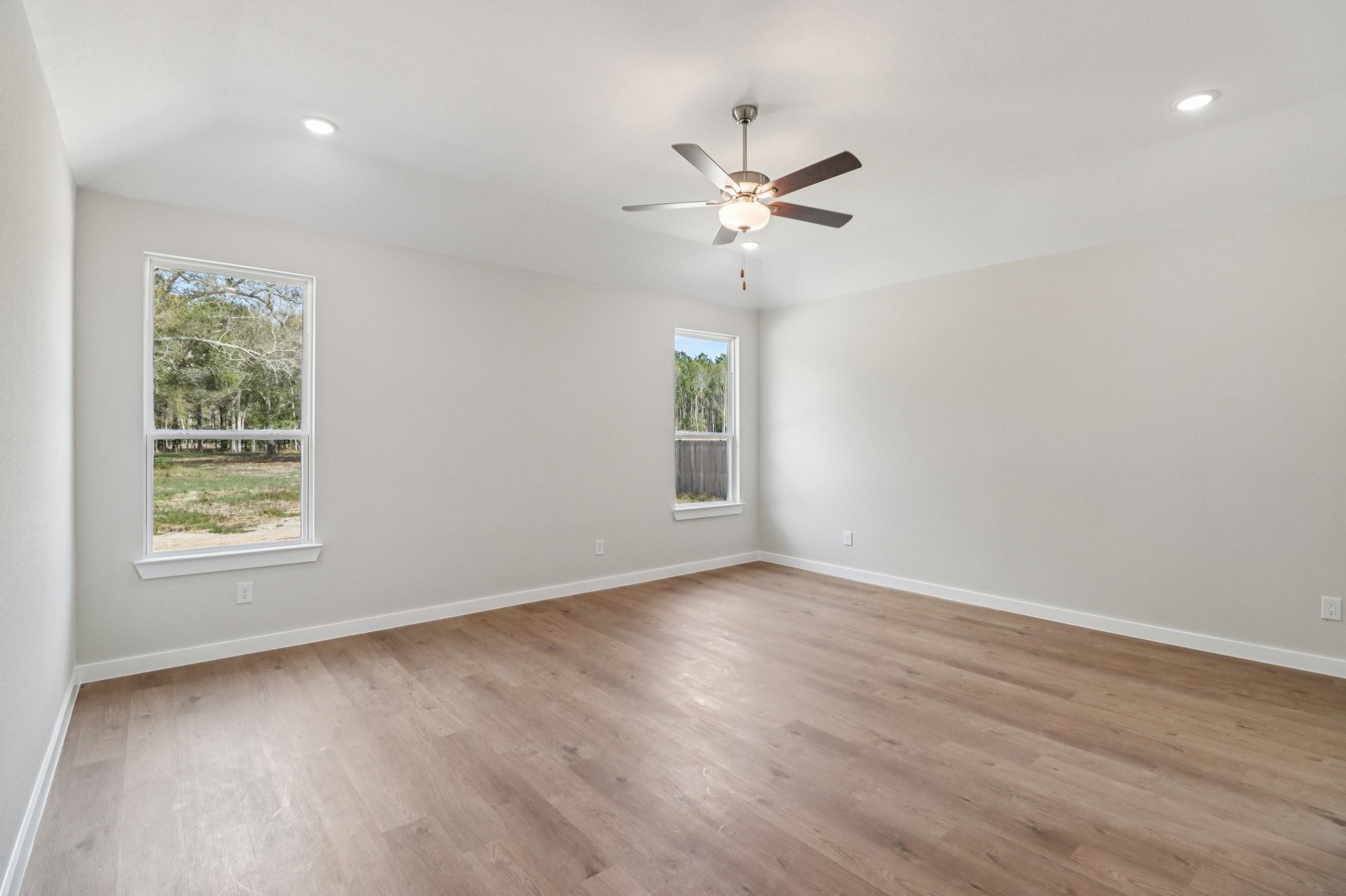 13424 Maverick Trail Road Conroe, TX 77303 - Photo 21 of 35 a view of an empty room with a window and wooden floor