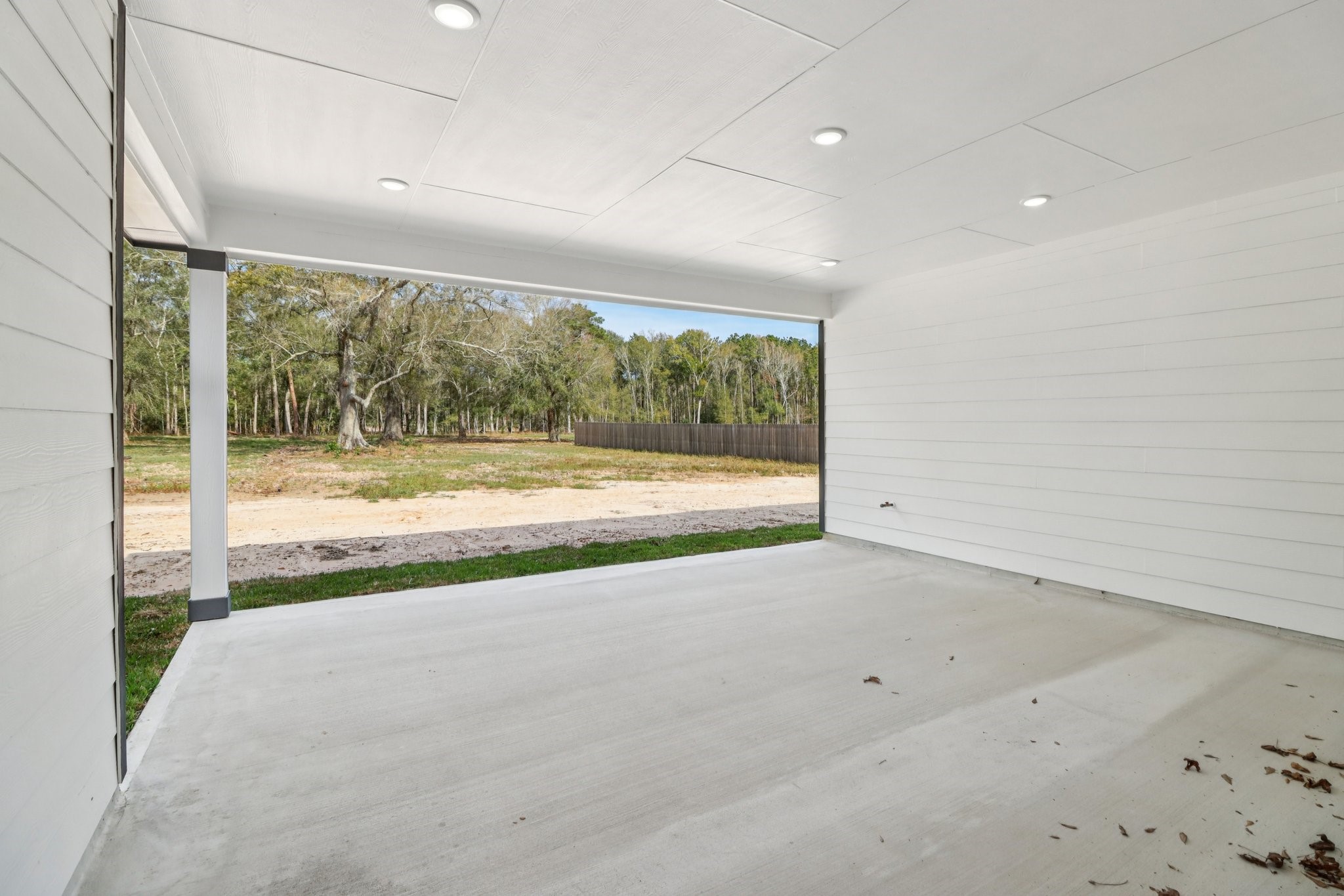 13424 Maverick Trail Road Conroe, TX 77303 - Photo 31 of 35 an empty room with wooden floor and windows