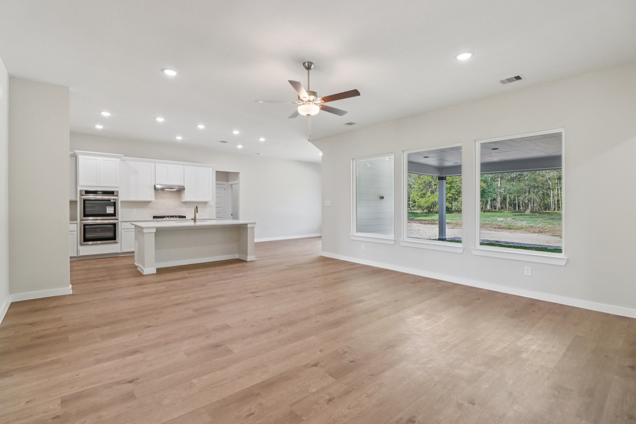 13424 Maverick Trail Road Conroe, TX 77303 - Photo 4 of 35 a view of kitchen with wooden floor and window
