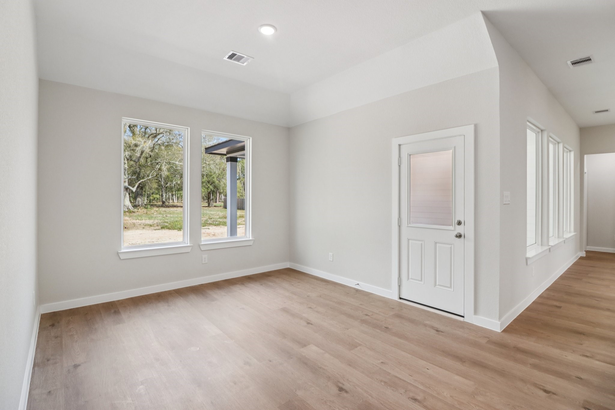 13424 Maverick Trail Road Conroe, TX 77303 - Photo 7 of 35 a view of an empty room with wooden floor and a window