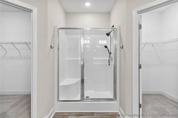 a bathroom with a glass shower door