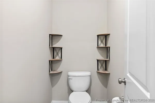 a white toilet sitting next to a bathroom sink