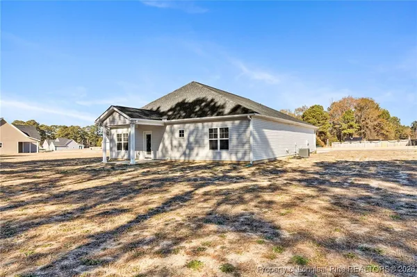 a front view of a house with a big yard