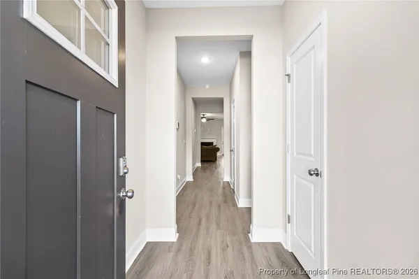 a view of a hallway with wooden floor