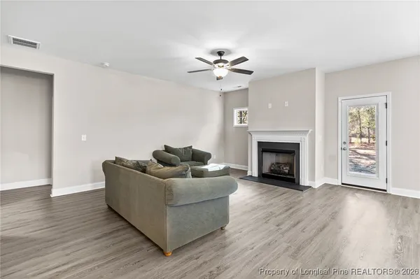 a living room with furniture and a fireplace