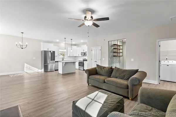 a living room with furniture and kitchen view