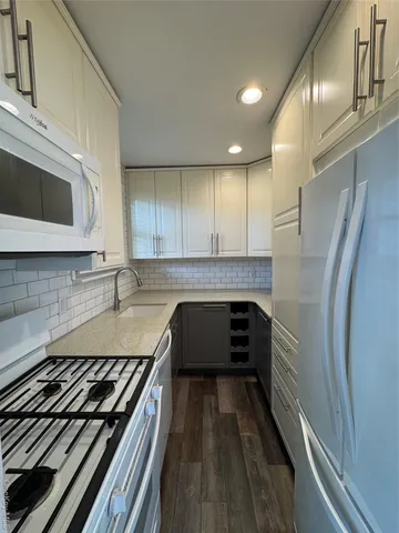 a kitchen with wooden cabinets and a stove top oven