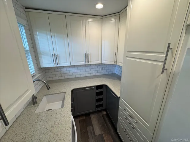 a kitchen with a sink and cabinets