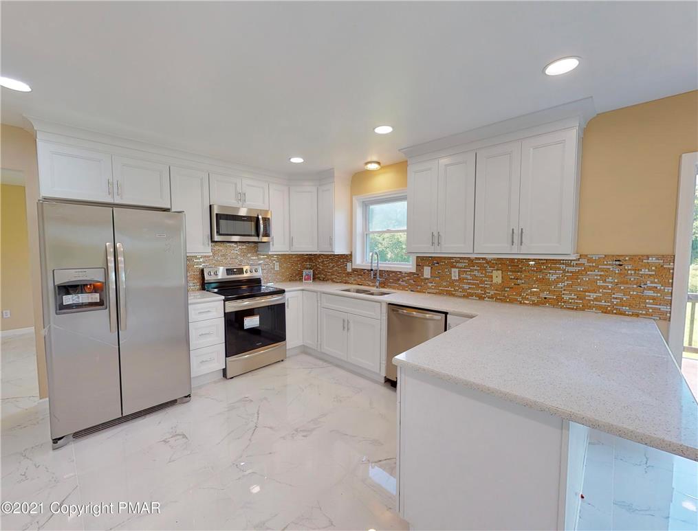 1110 Misty Ridge East Stroudsburg, PA 18302 - Photo 12 of 43 A well-appointed kitchen showcasing contemporary stainless steel appliances and crisp white cabinetry.