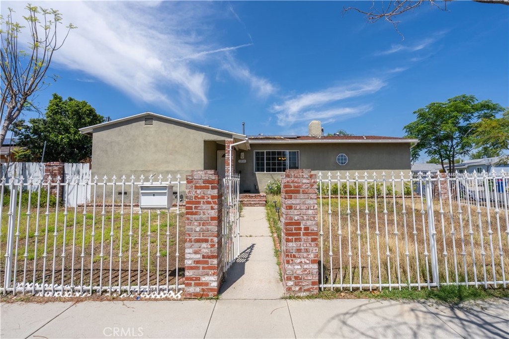 13655 Chase Street Arleta, CA 91331 - Photo 1 of 34 a front view of a house with a garden