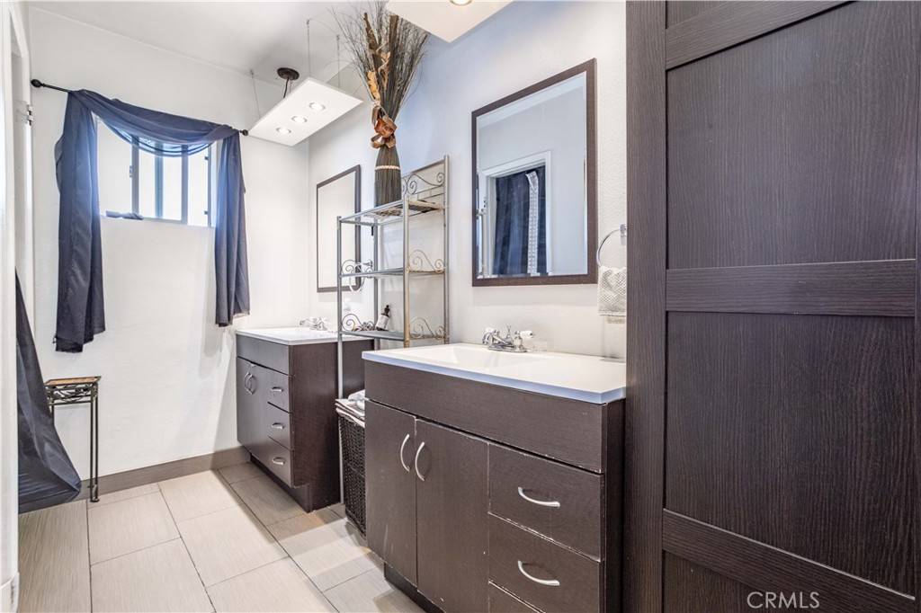 13655 Chase Street Arleta, CA 91331 - Photo 15 of 34 a bathroom with a sink a toilet and mirror