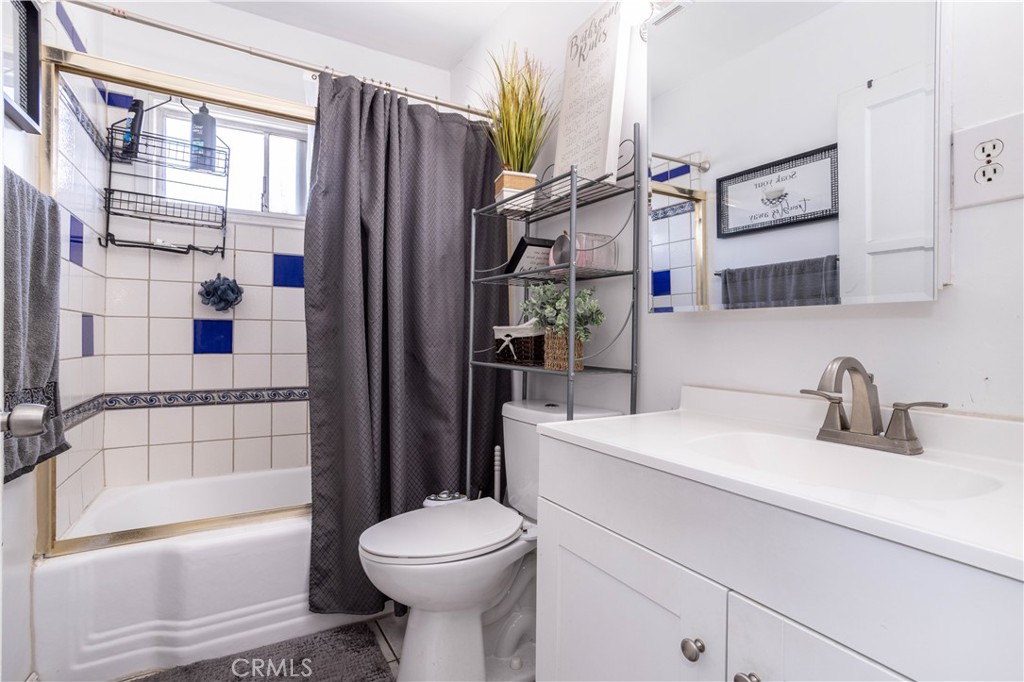 13655 Chase Street Arleta, CA 91331 - Photo 17 of 34 a bathroom with a sink a toilet and shower