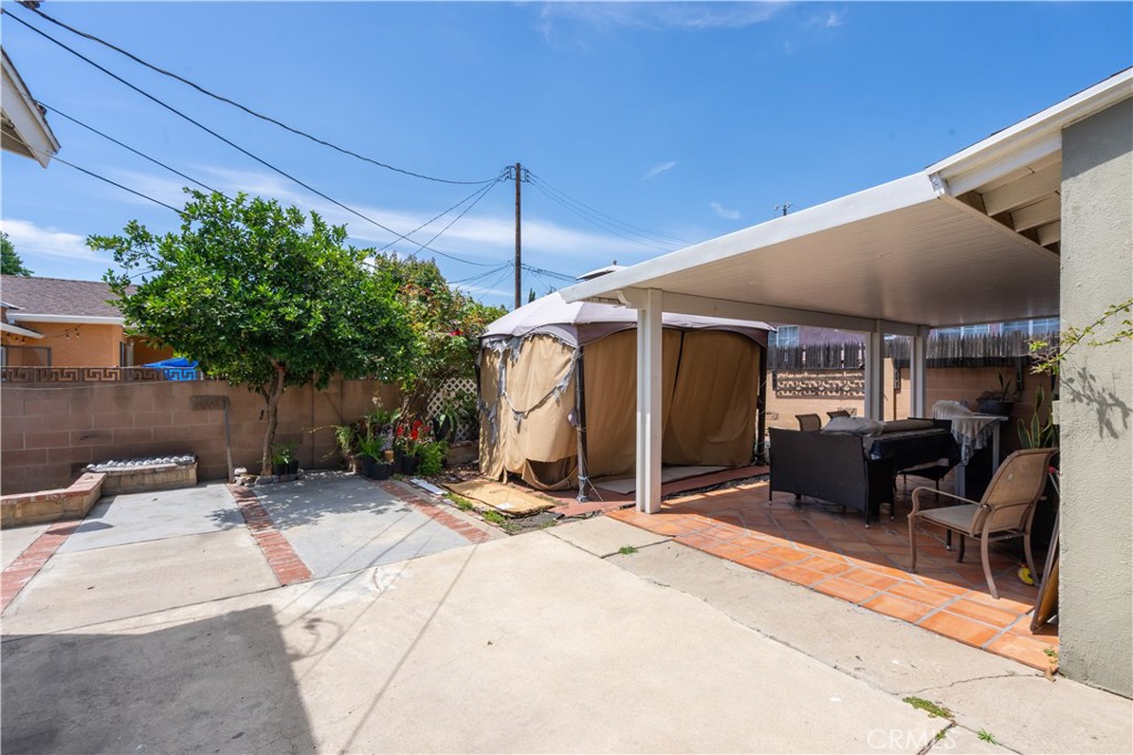13655 Chase Street Arleta, CA 91331 - Photo 29 of 34 a view of a patio with a table and chairs under an umbrella