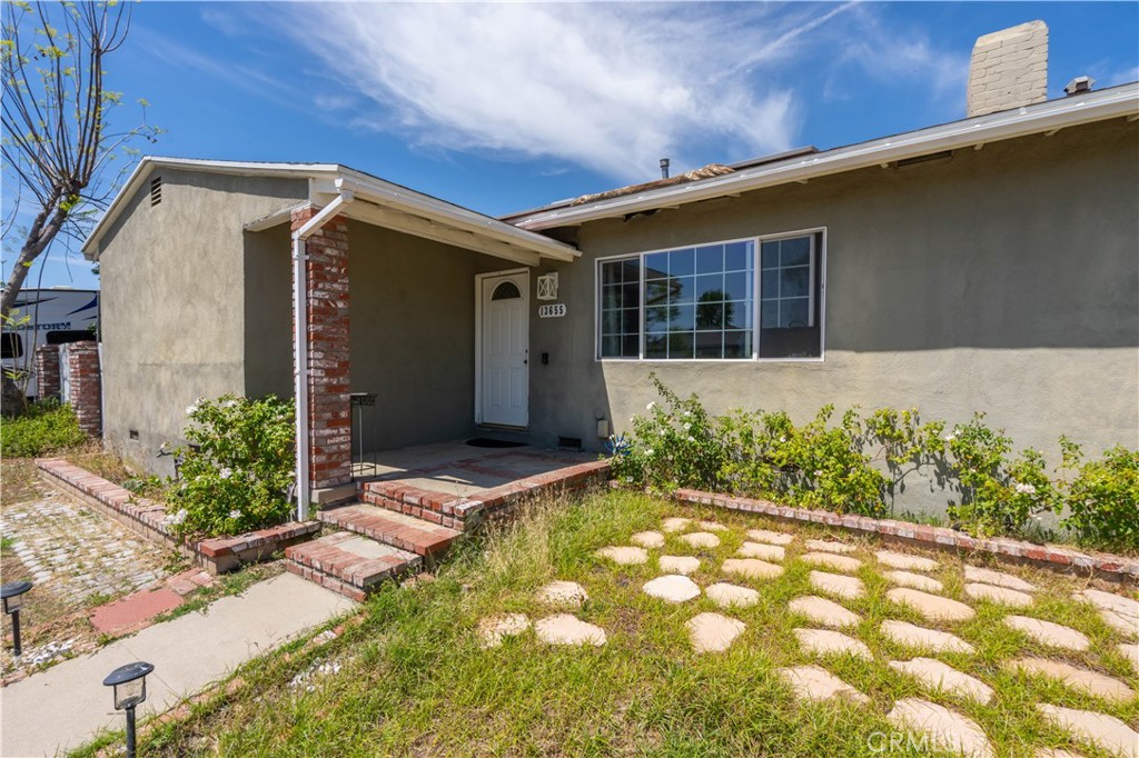 13655 Chase Street Arleta, CA 91331 - Photo 3 of 34 a front view of house with pathway