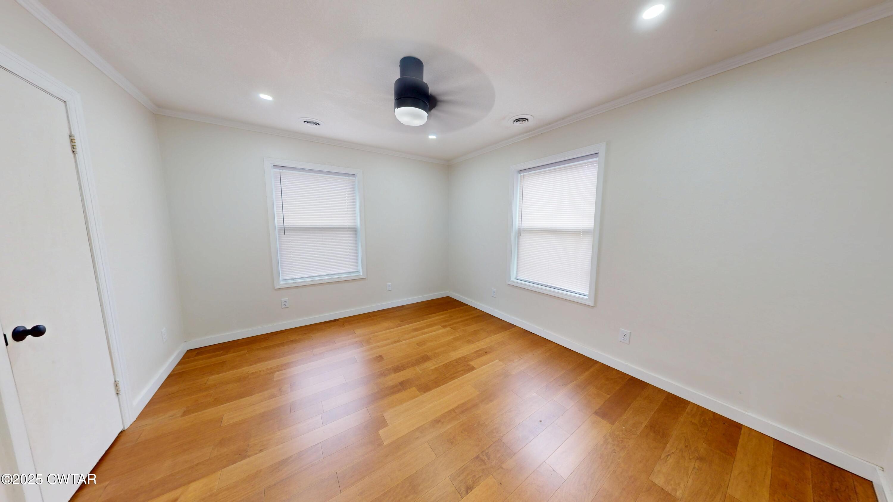 712 West Main Street Newbern, TN 38059 - Photo 13 of 27 a view of empty room with wooden floor and fan
