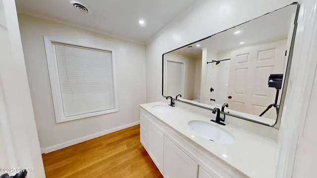 a bathroom with a sink a toilet and a mirror