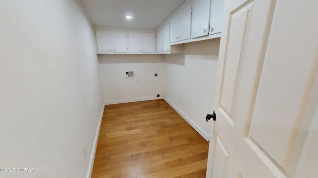 a view of a kitchen with white cabinets