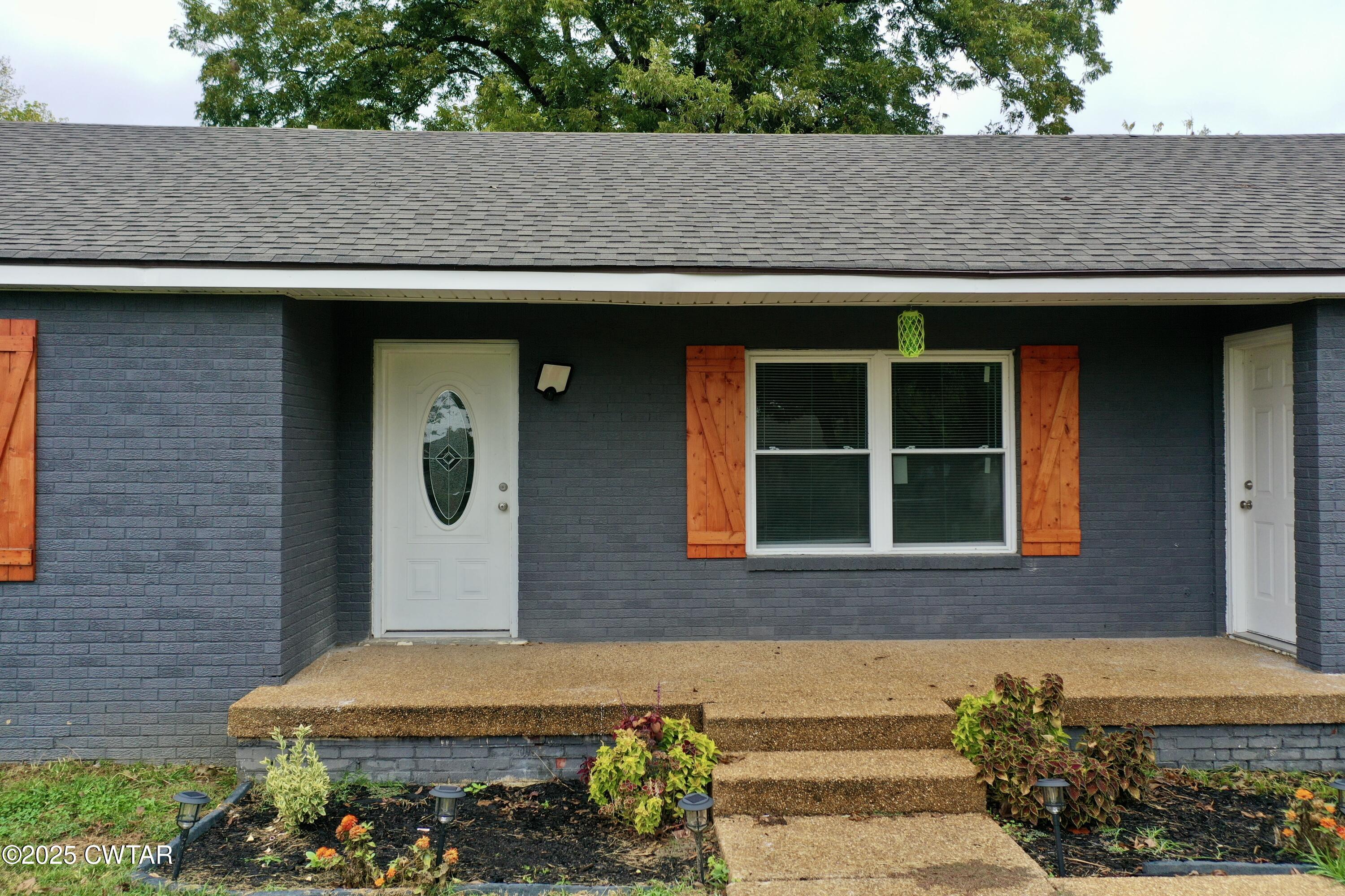 712 West Main Street Newbern, TN 38059 - Photo 22 of 27 a front view of a house with a yard