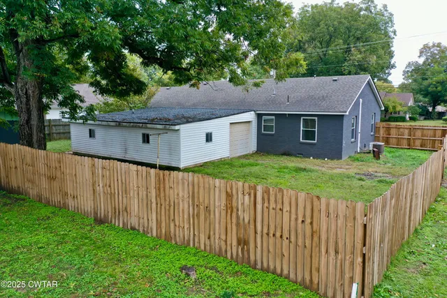 a view of a house with wooden fence