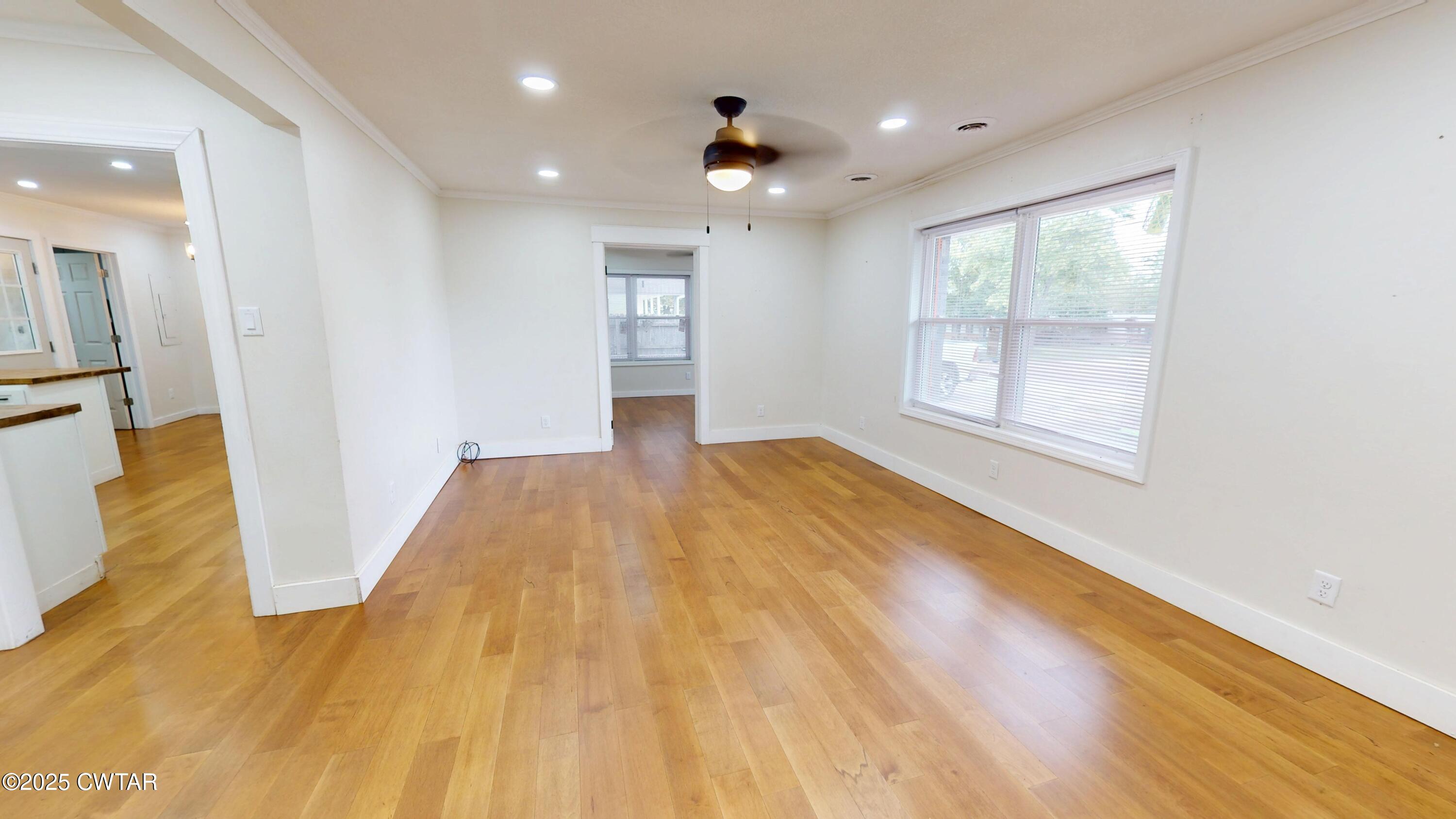 712 West Main Street Newbern, TN 38059 - Photo 4 of 27 a view of empty room with wooden floor and fan