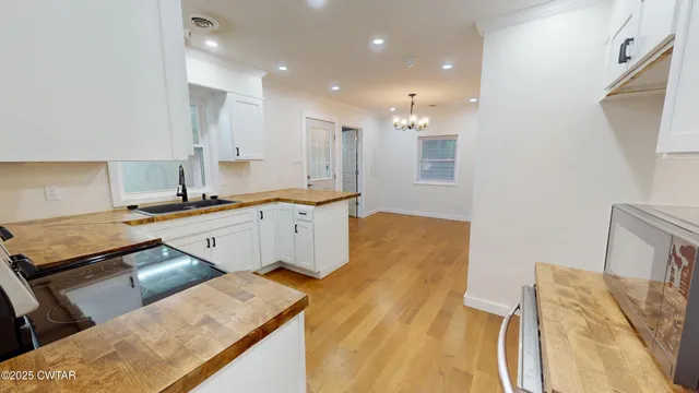 a kitchen with stainless steel appliances granite countertop a sink and a stove