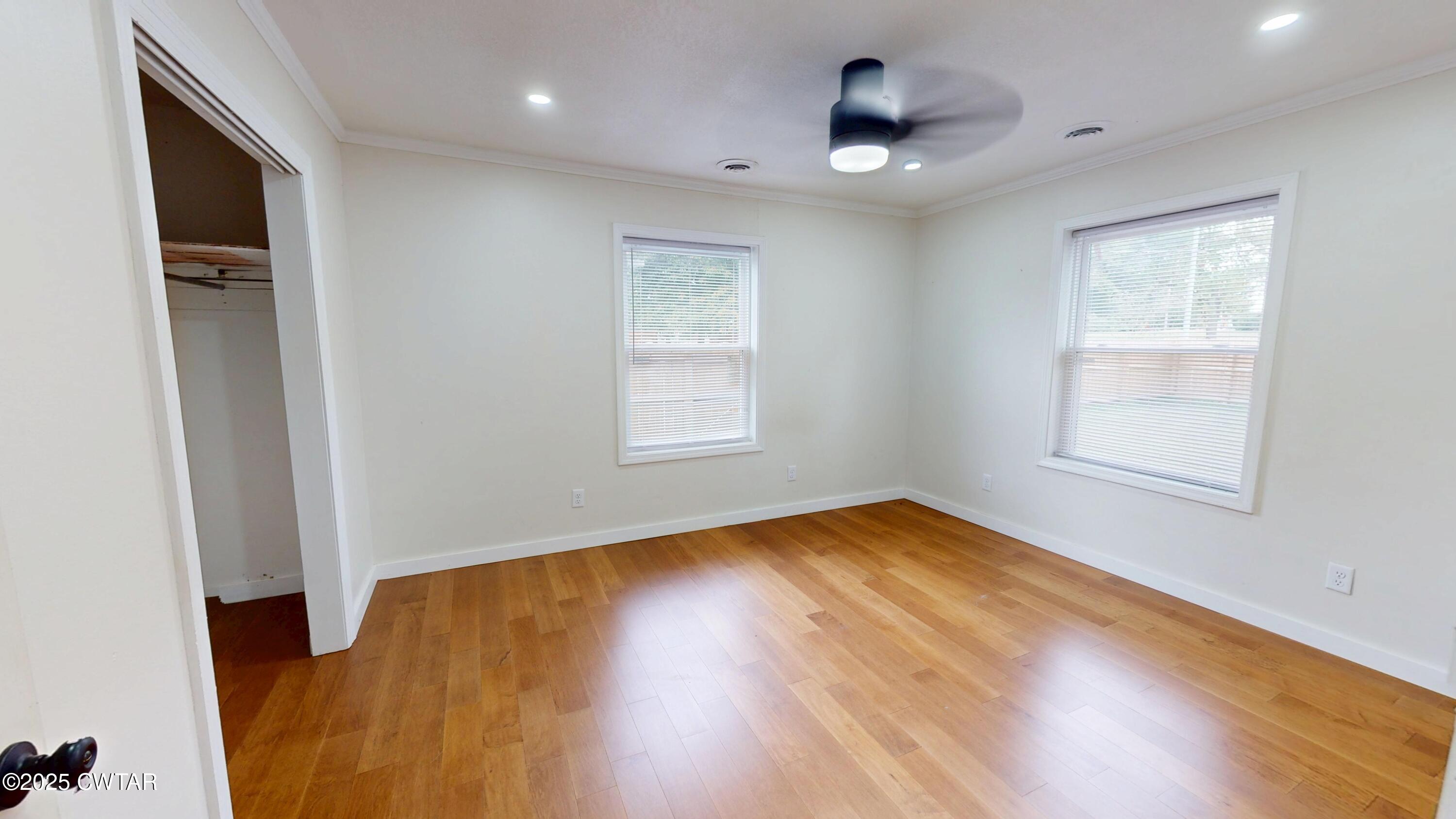 712 West Main Street Newbern, TN 38059 - Photo 9 of 27 a view of an empty room with wooden floor and a window