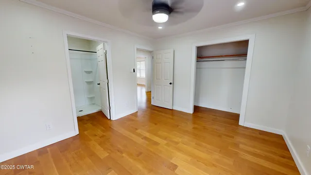 a view of empty room with wooden floor