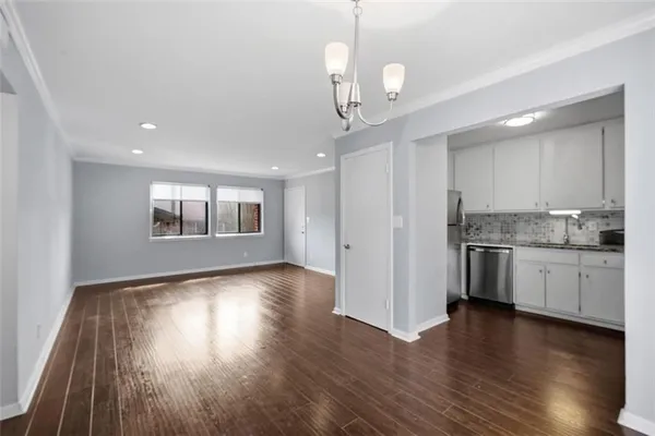 a view of a kitchen with a dishwasher cabinets and wooden floor