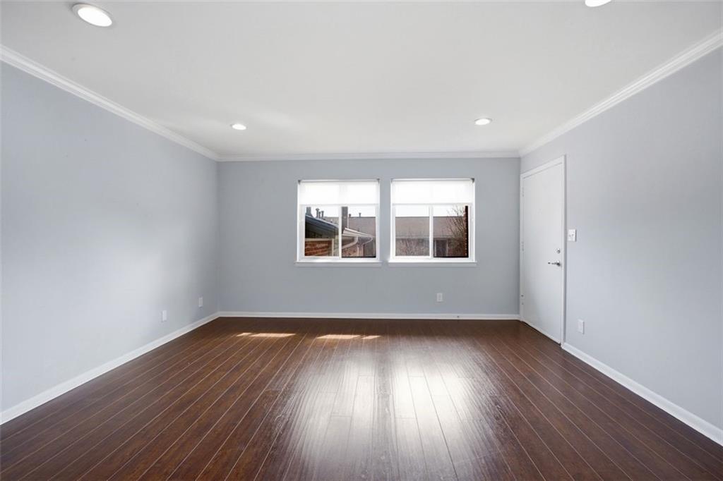 4266 Roswell Road Northeast, Unit E4 Atlanta, GA 30342 - Photo 12 of 24 a view of empty room with wooden floor and fan