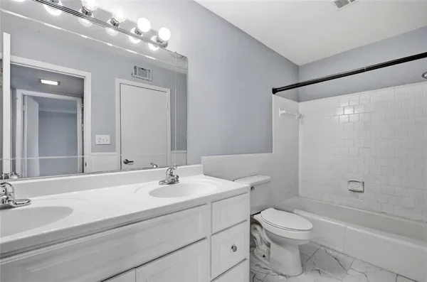 a bathroom with a sink vanity and a mirror