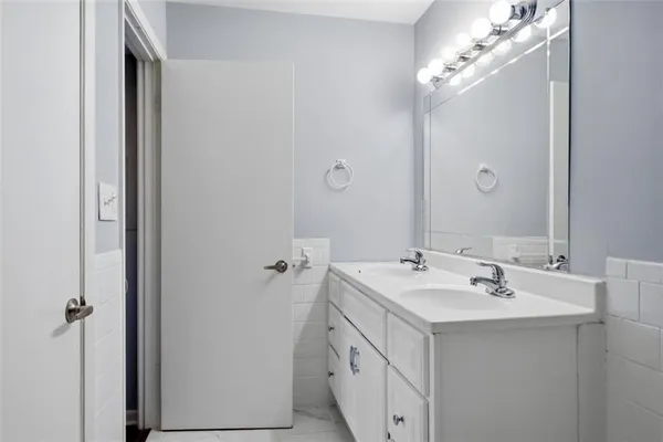 a view of kitchen with refrigerator stove and wooden floor