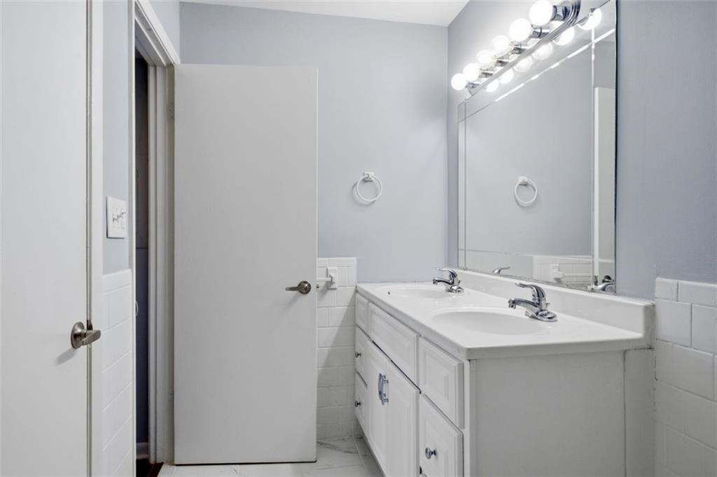 4266 Roswell Road Northeast, Unit E4 Atlanta, GA 30342 - Photo 16 of 24 a bathroom with a sink vanity and a mirror
