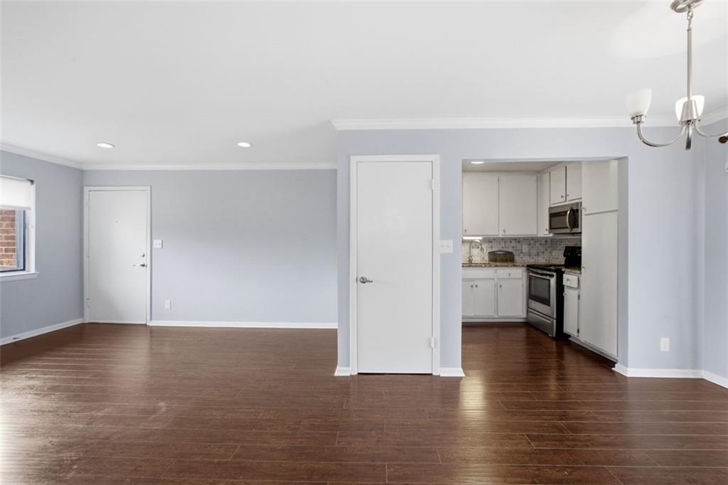 4266 Roswell Road Northeast, Unit E4 Atlanta, GA 30342 - Photo 17 of 24 a view of kitchen with refrigerator stove and wooden floor