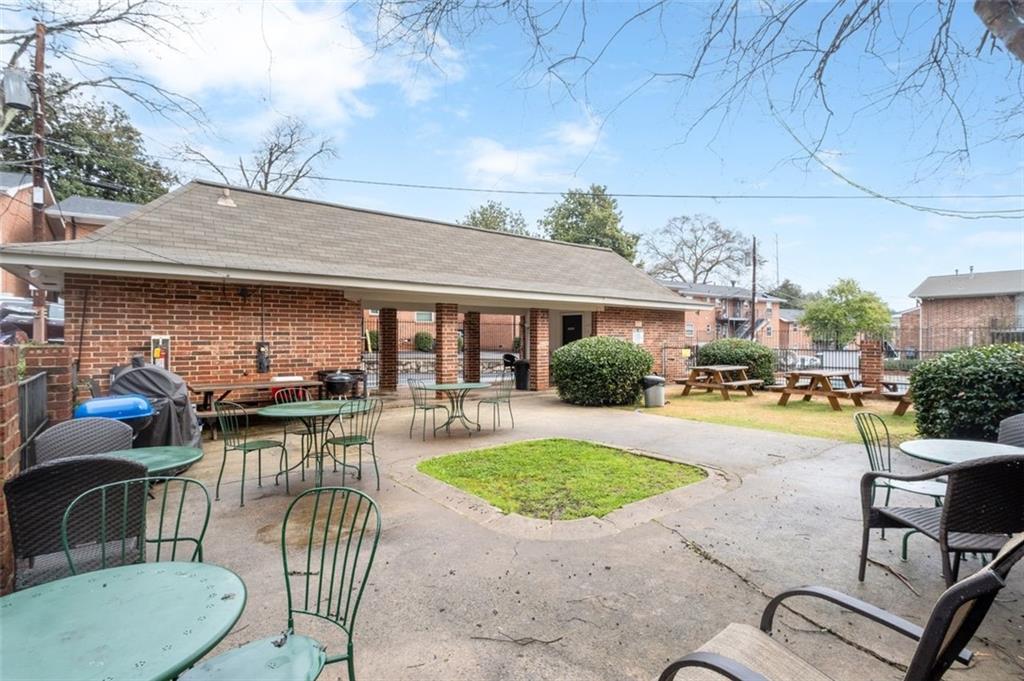 4266 Roswell Road Northeast, Unit E4 Atlanta, GA 30342 - Photo 22 of 24 a view of a patio with couches table and chairs under an umbrella