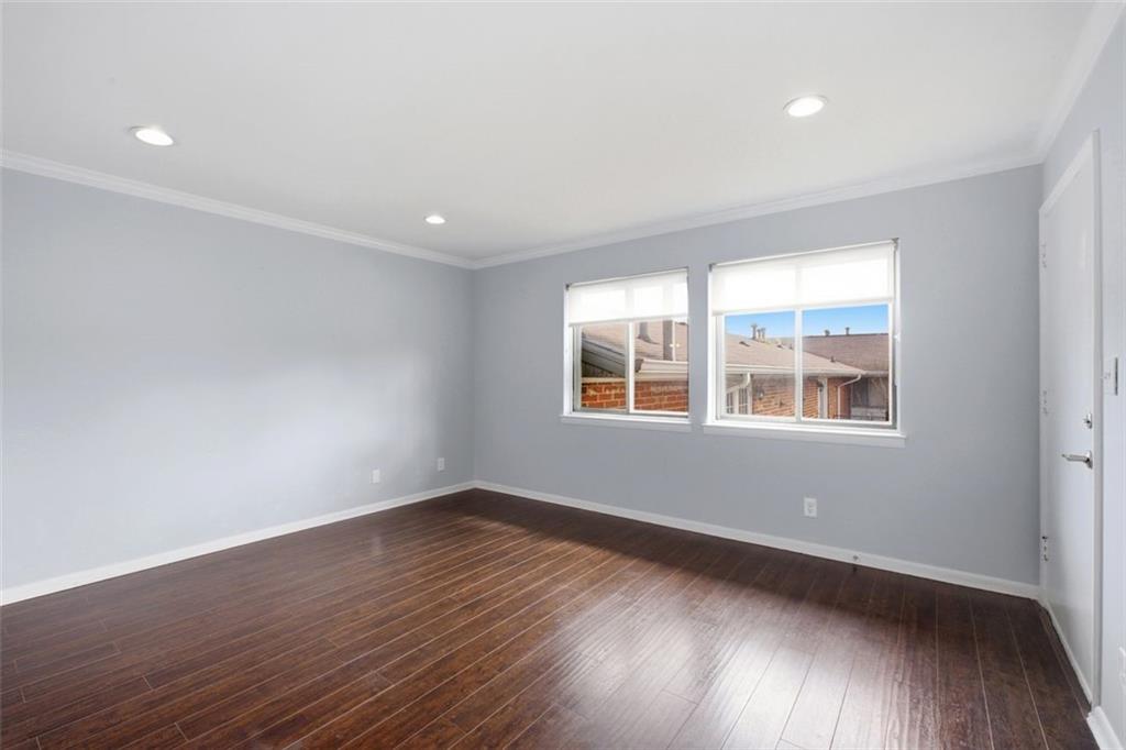 4266 Roswell Road Northeast, Unit E4 Atlanta, GA 30342 - Photo 5 of 24 wooden floor in an empty room with a window
