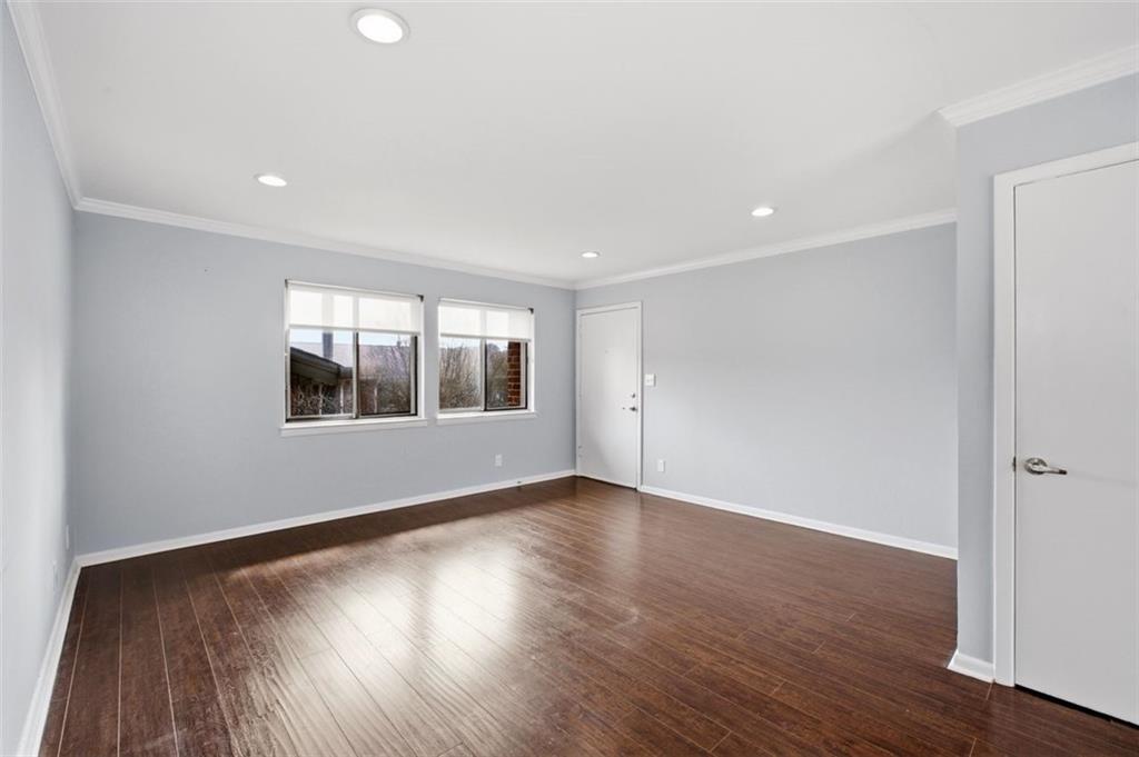 4266 Roswell Road Northeast, Unit E4 Atlanta, GA 30342 - Photo 7 of 24 a view of an empty room with wooden floor and a window