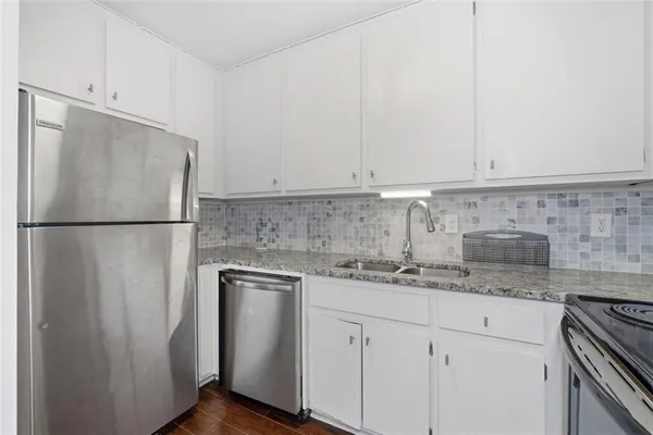a kitchen with stainless steel appliances a stove microwave and cabinets