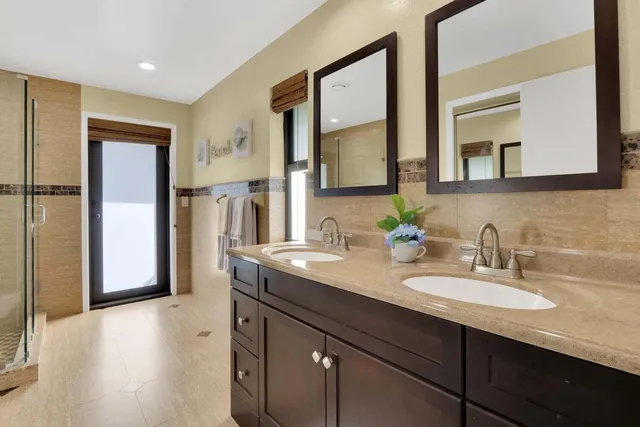 a bathroom with a sink double vanity and a mirror